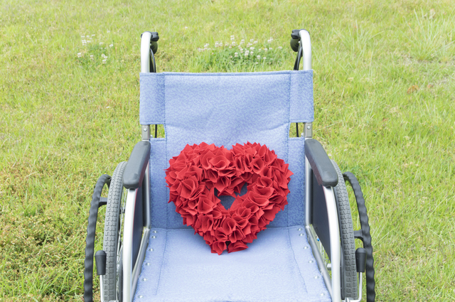 車いすに赤い花のハート形